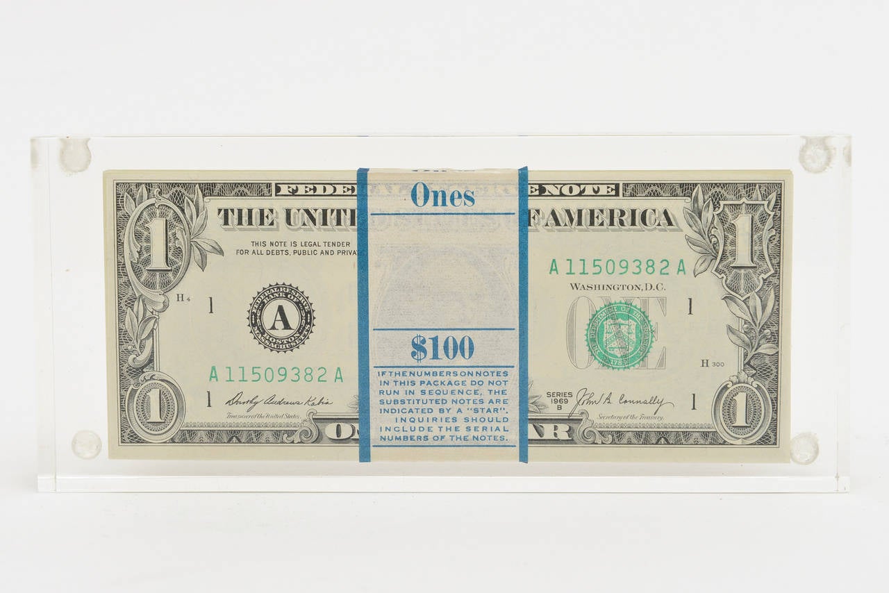 This pop art vintage Lucite sculpture has the illusion of many hundreds of dollar bills inside. It is our understanding that only the front and back are real but who really knows. This is the real question. It looks like a banded form of dollar