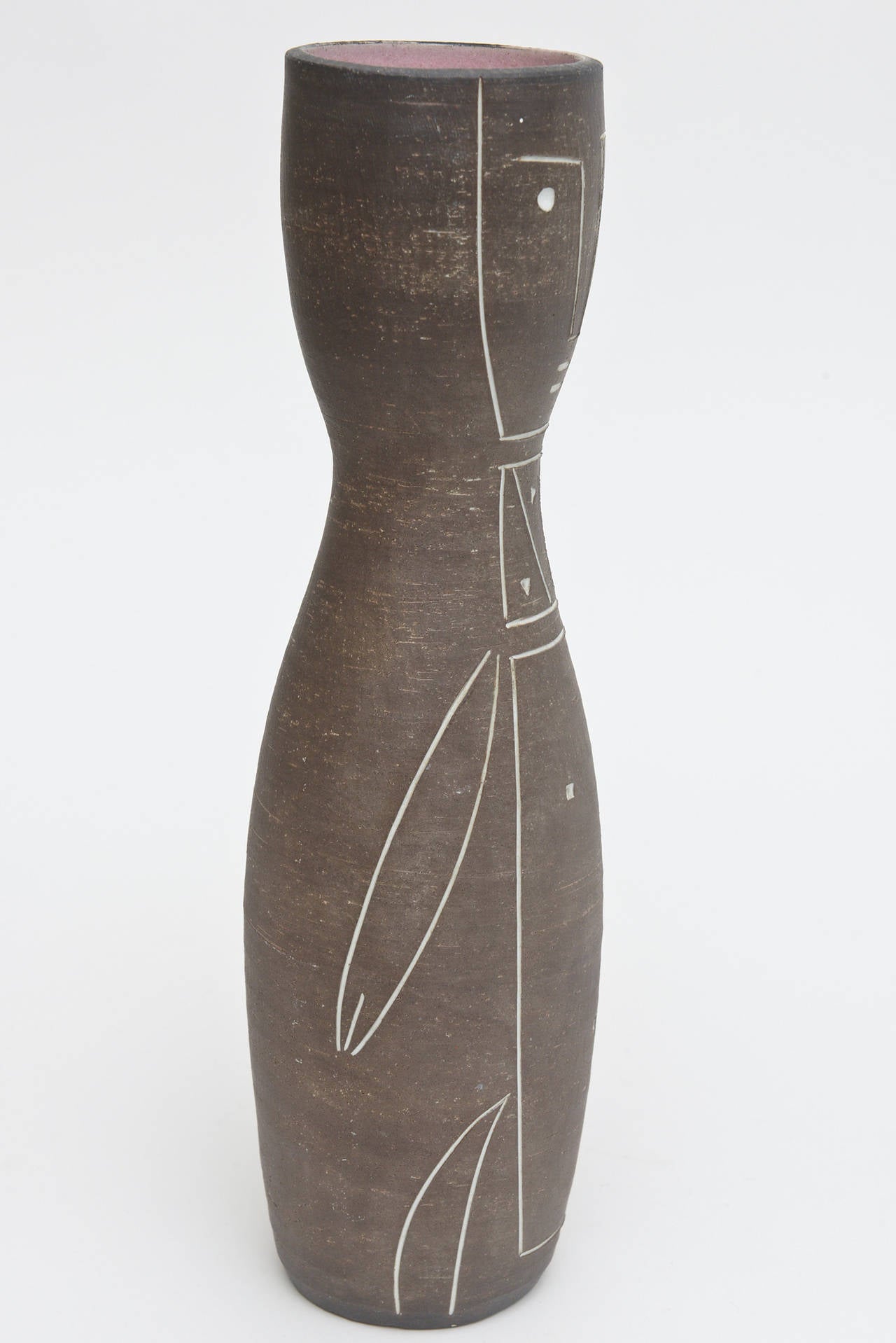 Primitive meets linear meets Miro influence in this Mid-Century ceramic vessel or vase sculpture. The dusty rose glaze on the inside makes a good contrast to the light brown background. With incised white lines. It is signed on the bottom but not
