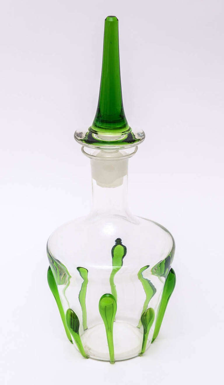 The dimensional applied luscious Kelly green glass applied teardrops against the clear glass Italian Murano glass decanter makes this a statement piece. The original exaggerated large stopper is also that great green. It is 7.5