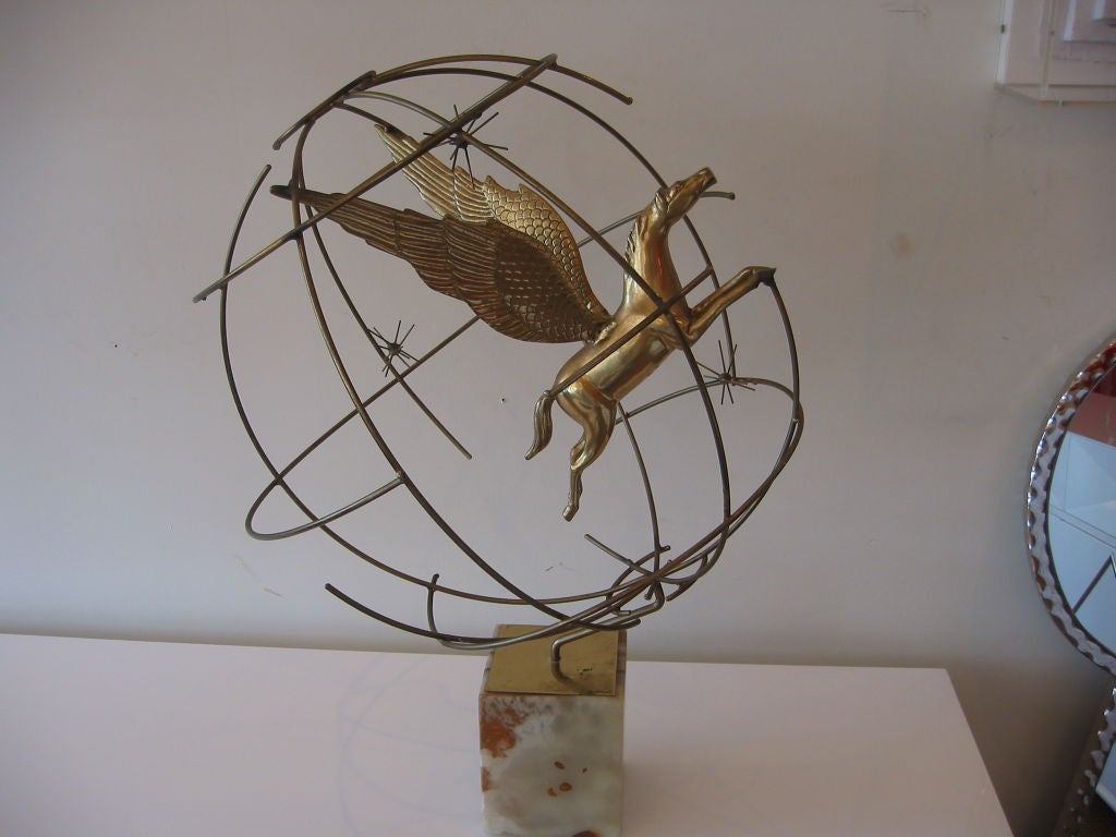 Rare Jere brass sculpture of pegasus suspended within a brass spherical cage. Pivoting on a marble block with a brass top plate which has the signature and the date. Naturally patinated, this wonderful sculpture also has galaxy sputniks mounted in