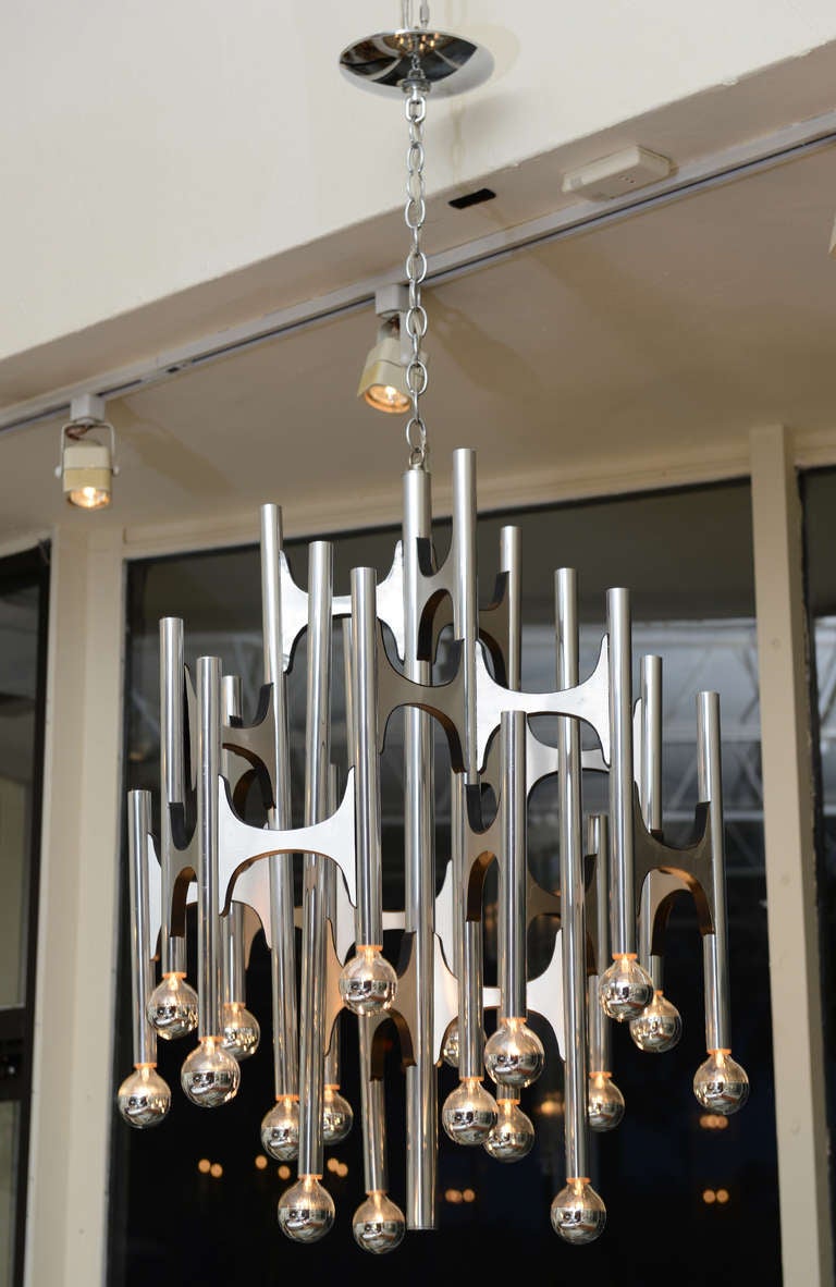 Chrome and black wood are the backbone of this very architectural inspired chandelier by the Italian: Gaetano Sciolari... It has custom chrome tipped custom bulbs that go all over the chandelier; note all the bulbs are not shown but come with the