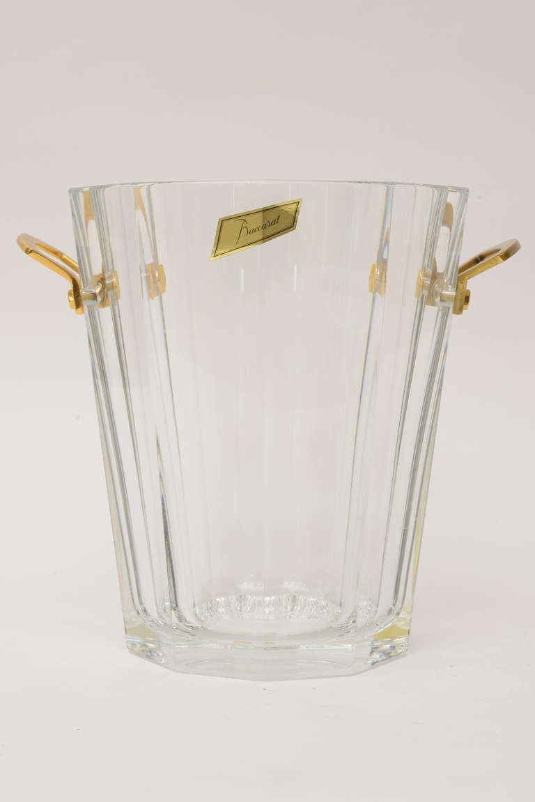 This wonderful and substantial crystal /bronze ice bucket is timeless.
Elegant with restraint...
The bronze handles on either side adorn the crystal.
It retains the original label of Baccarat.

The inside of the glass is 7.5