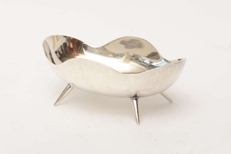 This wonderful sterling silver signed bowl has splayed legs. It is very sculptural!
It is from Mexico and perfect for serving or just as is.

It is hallmarked 925... made in Mexico with a monogram of JR.