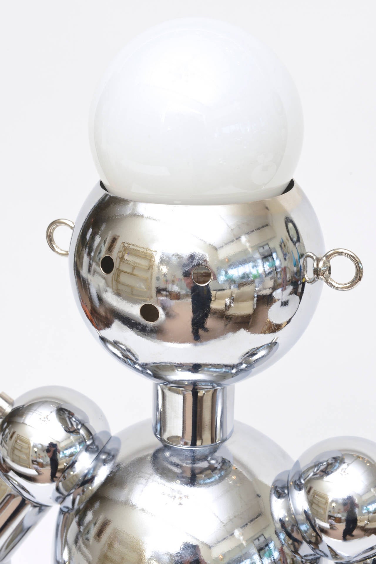 This wonderful Italian whimsical Space Age robot lamp is vintage and newly re-chromed and re-wired. The bulbous bulbs as the head and arms can light up together or separate.
The wonderful ambient lighting that comes from a three-way switch has warm