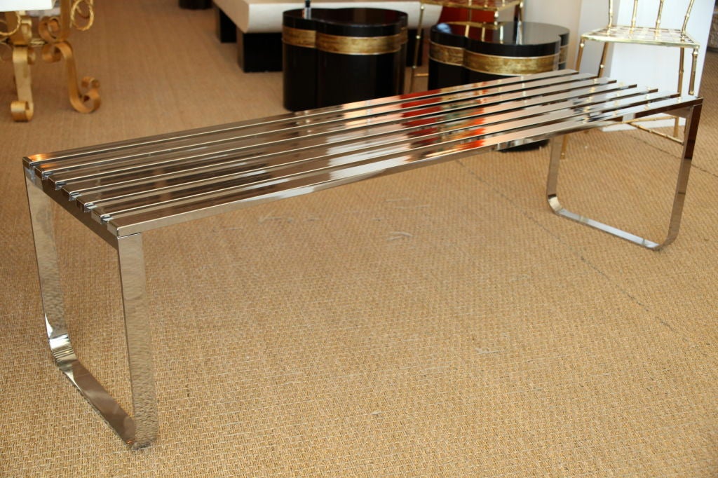 This fabulous bench by DIA acts as a piece of art and sculpture.  It is very architectural with its high polished exposed slats and formed legs.   There is an original DIA manufacturers sticker on the underside.