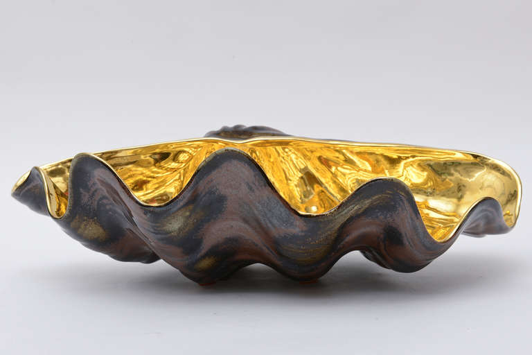 This amazing and beautiful  vintage Italian Buccellati porcelain shell has the interior of sheer richness with it's 24 carat gold overlay over the glazed porcelain.
As a centerpiece, it is divine.,as a object/sculpture on any table, it rings of