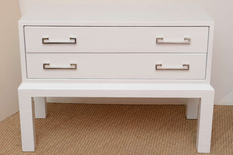 These wonderful 2 drawer nightstands have great table top space and drawer space. The original pulls have been newly nickeled silver over the brass.
They are white lacquer over linen and so in the style of Karl Springer.
They make great size night