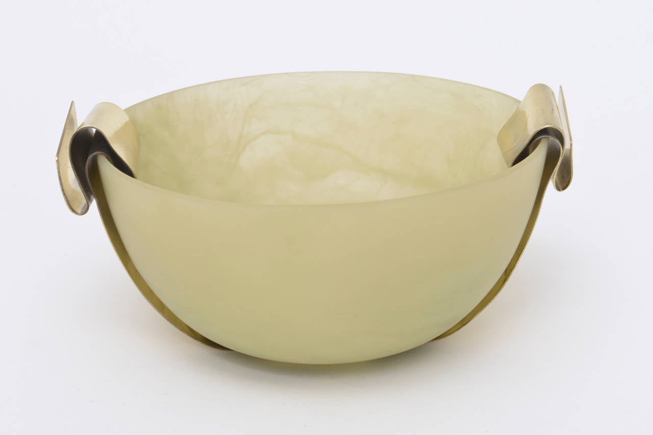 This designer; Martha Sturdy from Vancouver lends herself to influences of jewelry forms. The sage green resin bowl has a beautiful band of polished bronze as the frame with each side folded under. Very sculptural! She tends to mix organic with