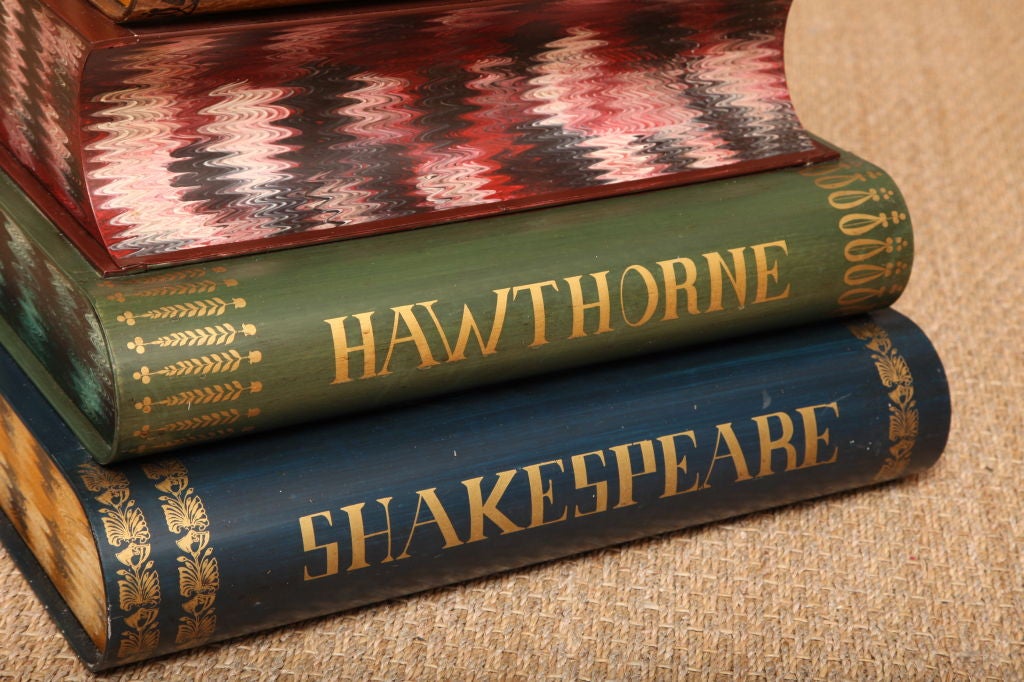 PRICED TO SELL.... This painted tole metal stacked book table features many of the greats, including Shakespeare, Hawthorne, Balzac, and Dante. The  five stacked books are exquisitely detailed with painted titles and banding. The top book features a