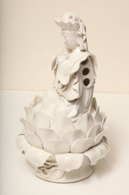 This rare blanc de chine porcelain statue features the beautiful and elegant Kuan Yin.  Kuan Yin is the goddess of compassion and mercy and is believed to alleviate pain and suffering.  She is exquisitely robed in a beautiful gown and headdress and