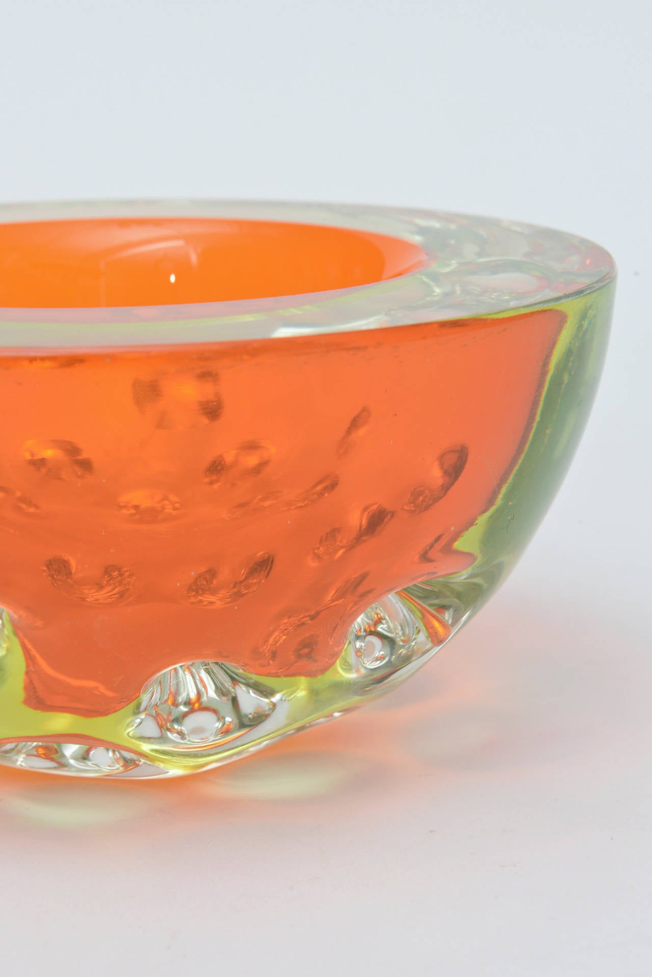 This amazing rare Italian Murano glass geode bowl has the luscious color of orange with a hint of yellow chartreuse Sommerso. It has the flat cut polished top. It is spectacular. Heavy and substantial in form, color and weight.
Orange is a special