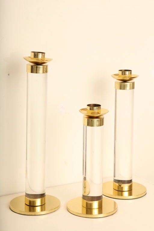 This great trio; set of three huge candlesticks make a dramatic statement for any coffee table, buffet, or even mantel. They have been newly polished, and new felt on the bottom.Please call for specific measurements. Truly, a great set!!!! They have