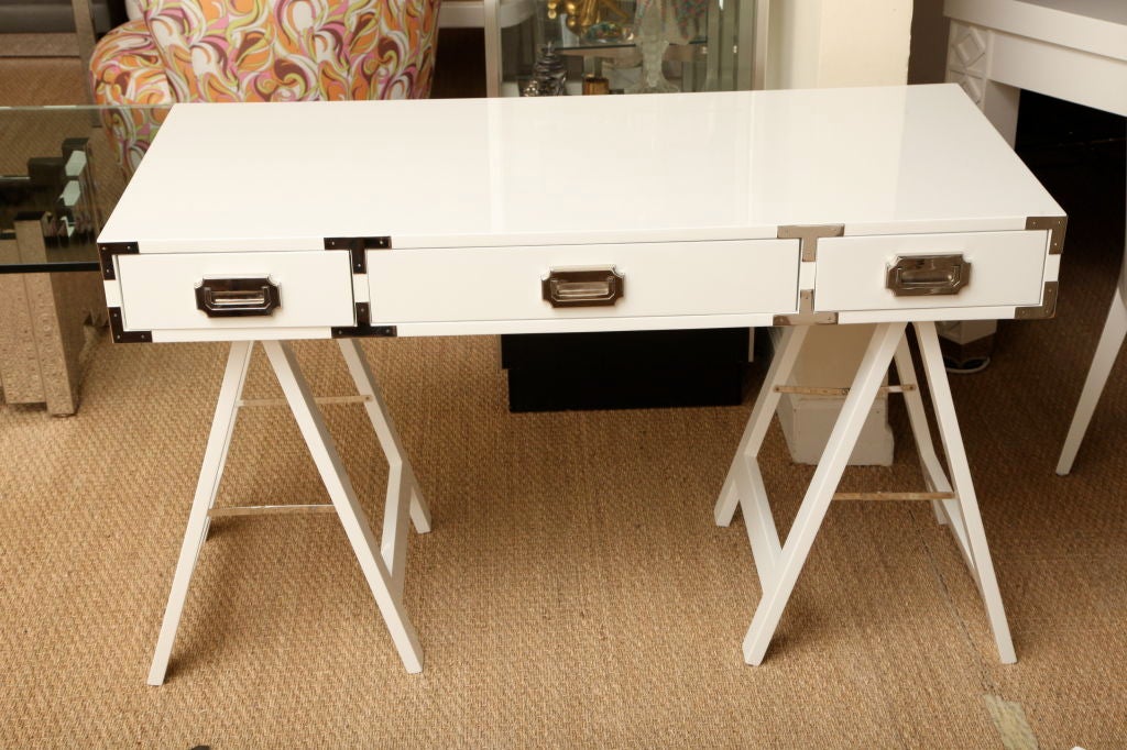This sleek and versatile campaign desk with it's beautiful nickel silver appointments , drawers and saw horse legs fits anywhere. Sleek, modernist, and well appointed.