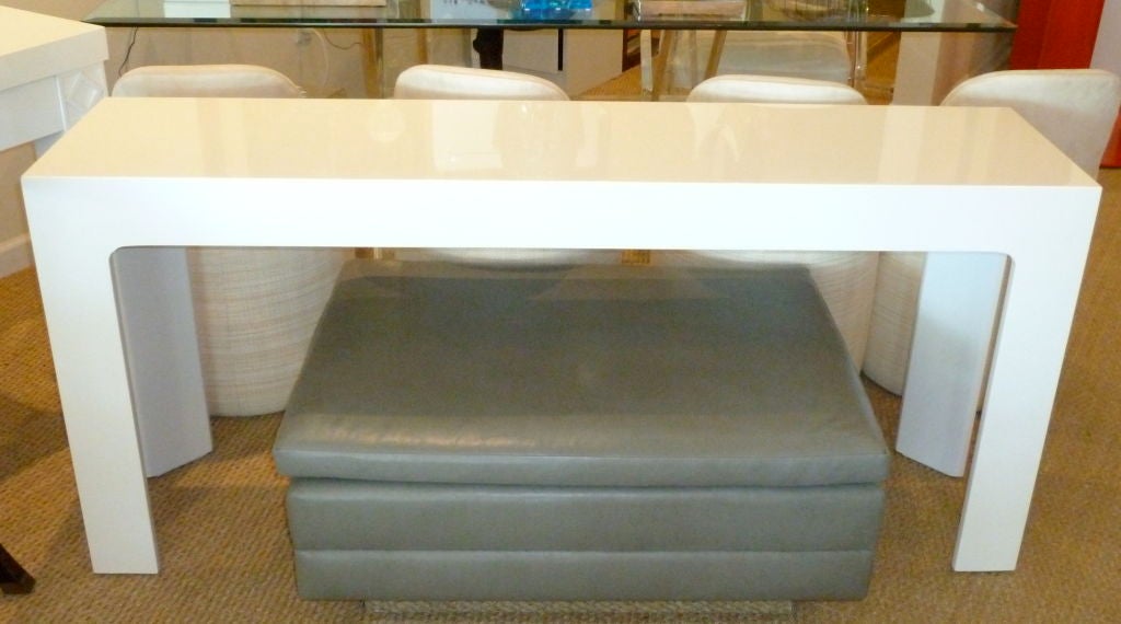 This simple; Parsons style console has angled legs... can be used behind a sofa or simple as a console.