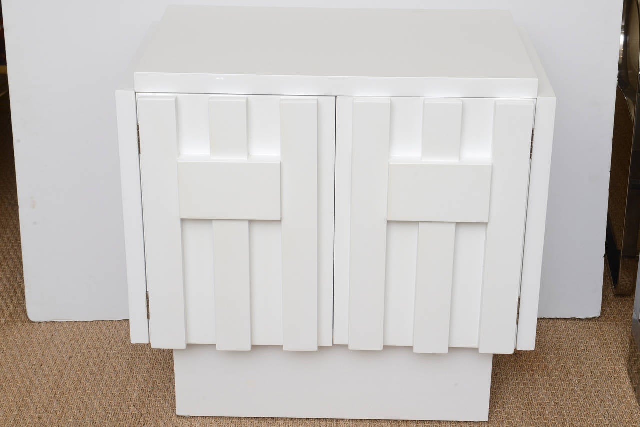 These are a great pair of period mid modern newly restored white lacquered nightstand or side tables. The cubist influence of raised dimensional wood forms lend a style to the work of the great artist Louise Nevelson. 
They are clean, sculptural