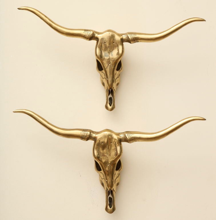 These formidable and dramatic pair of brass skulls make a great statement for any wall.They can be hung side by side or one on top of each other. They can also be formated as wall sconces at an additional cost. The measurement below is for each one.