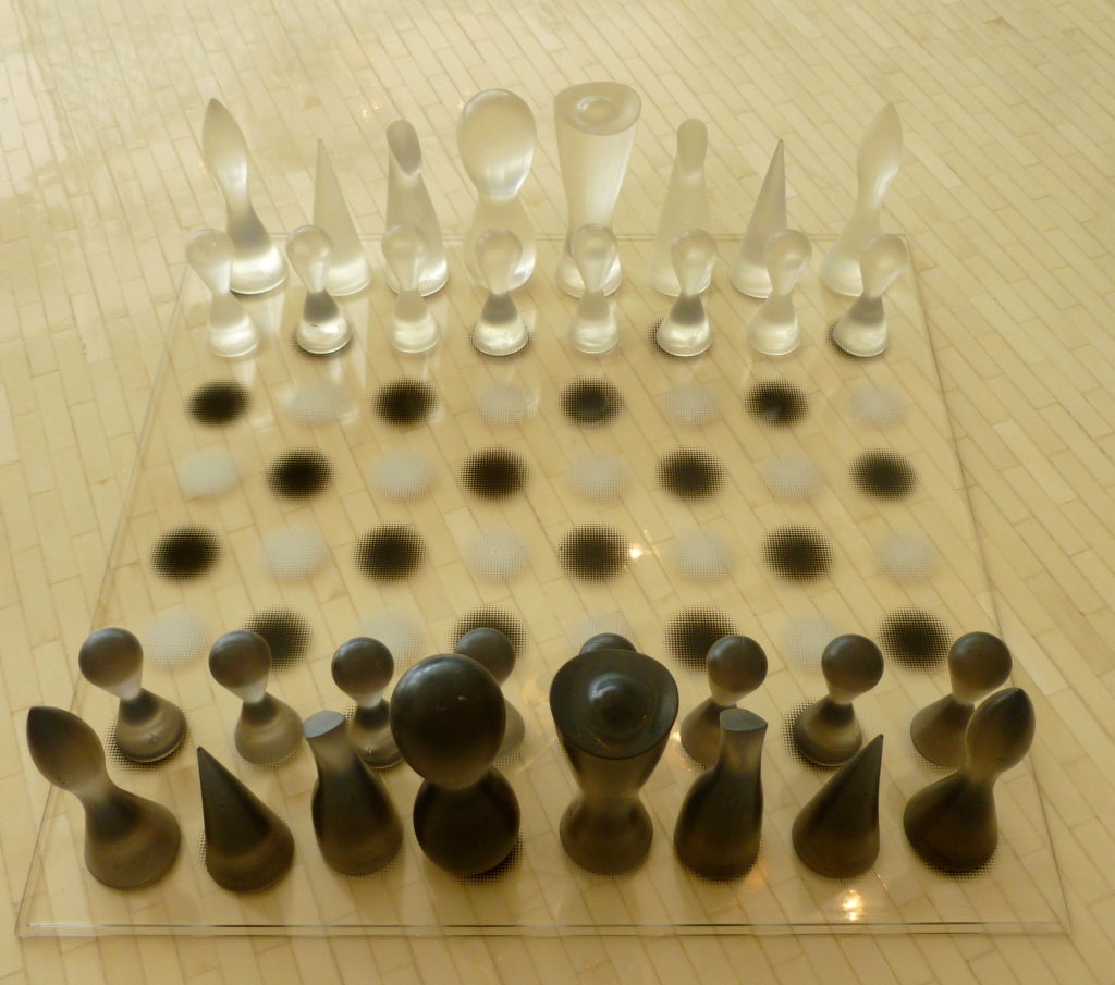 This sculptural and artistic black and clear chess set is by none other than Karim<br />
Rashid; the amazing  innovator of design. This hard to find chess set is out of production. It was produced  in 2002 by Bozart for Karim Rashid. The plexi