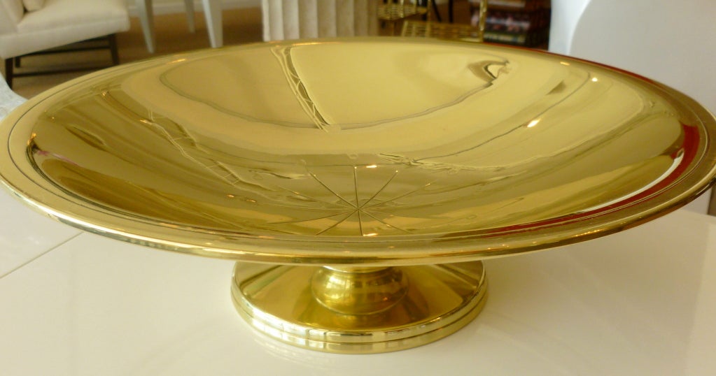 This wonderful footed bowl by Tommi Parzinger for Doryln Silversmiths has been beautifully polished to show its golden color. it is hallmarked on the bottom. The starburst design in the middle adds a beautiful touch. The bowl glistens in the light.