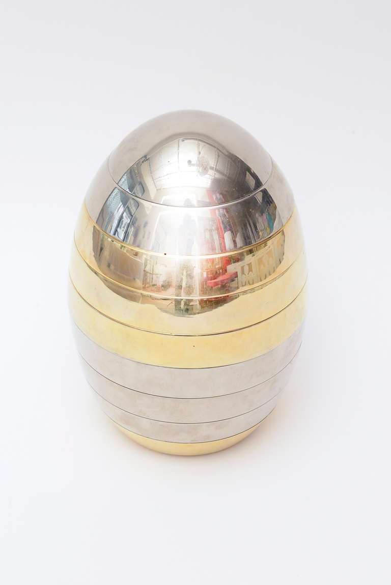 This Italian mixed metal chrome and brass stacking trays in the shape and form of an ovoid or egg make this now hard to find Tommaso Barbi sculptural fantastic object or serving piece a conversational piece!
It is sculpture and has utilitarian
