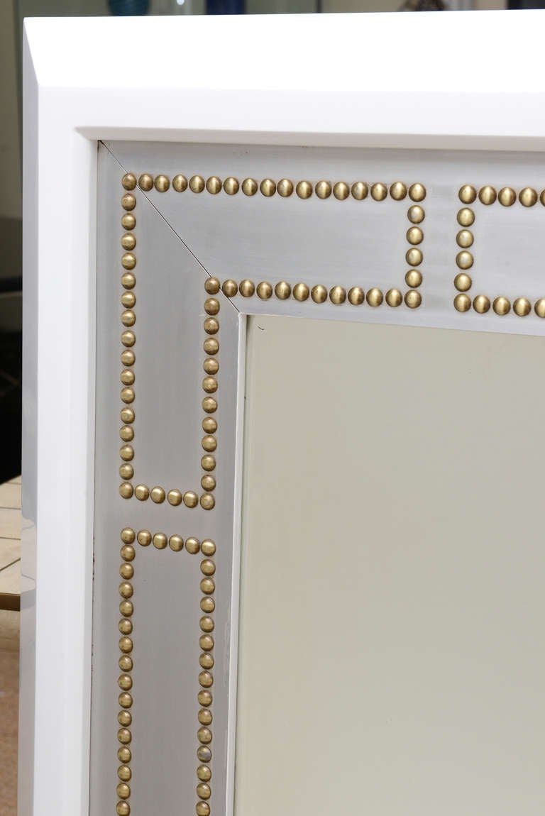 Fabulous mirror white lacquer over wood with the polished brass studs and stainless steel makes this mirror chic and modern! The beveled sides add dimension and an edge.
A stellar mirror!!!!