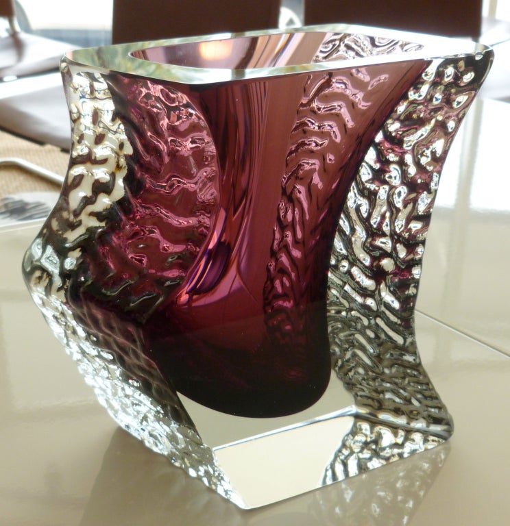 This sensual and luscious unusual vase is angled. The most arresting color of eggplant to purple to aubergine interior Sommerso glass is encased by the outer rippled clear glass the rippled texture on either side of each polished side gives the