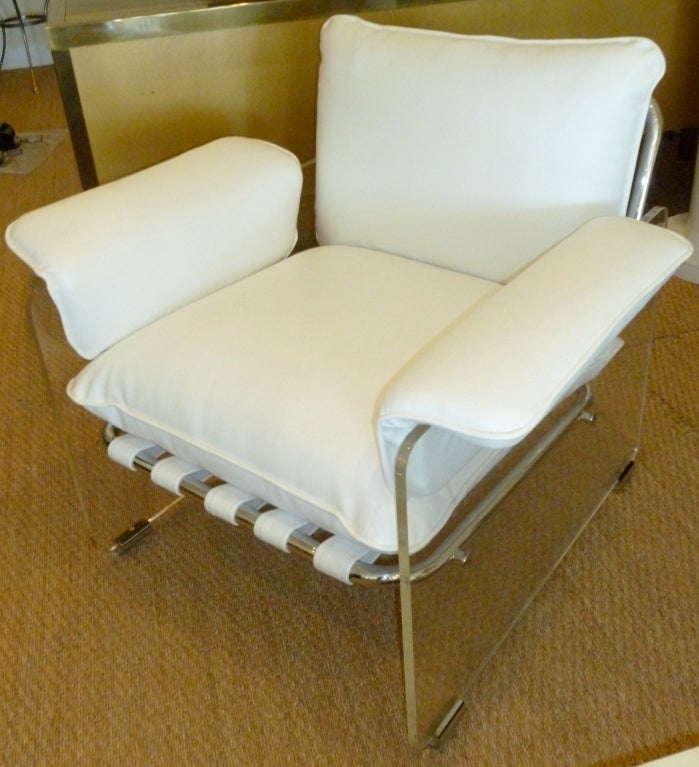 This stand out lounge chair is very heavy with it's lucite thick side panels. and chrome accents. Condition is very good. The upholstery is a white vinyl. The strapping on the back and bottom of the seat are exactly how it was made.