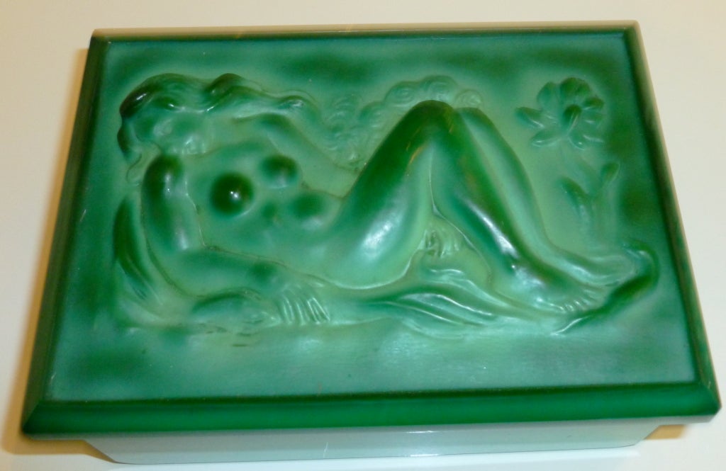 This arresting and sensual lidded box made out of glass in the color of luscious
malachite green is featured in the book