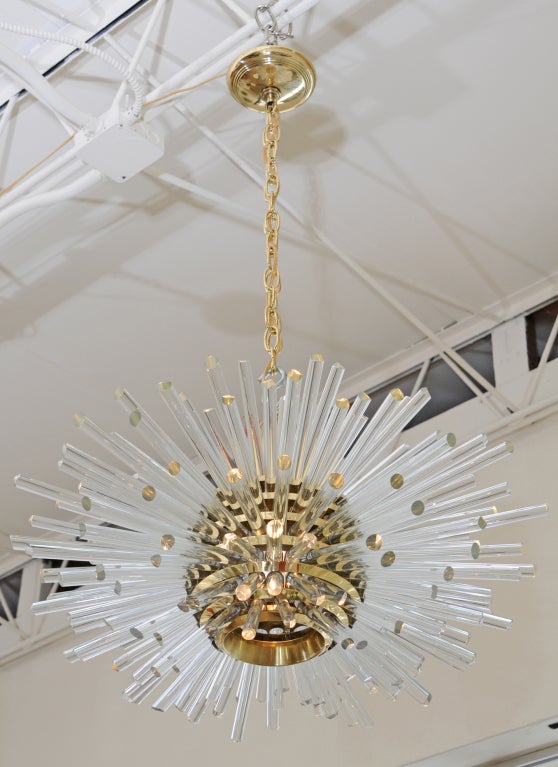 This amazing, elegant and radiant Austrian Crystal and Polished Brass 5 tier sputnick
chandelier is incredibly heavy; weighing about 120 lbs.  The play of light that radiates for the tip of the crystal rods create  brillance par excellence. The