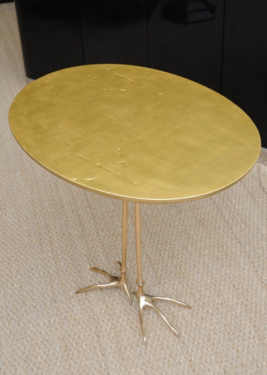 This piece of art/sculpture of an occassional oval ostrich table is very clever in the statement it makes.
The bird footprint is purposely  incised on the top of the table. Surrealism??? It is higher than most side tables, as it acts as an object