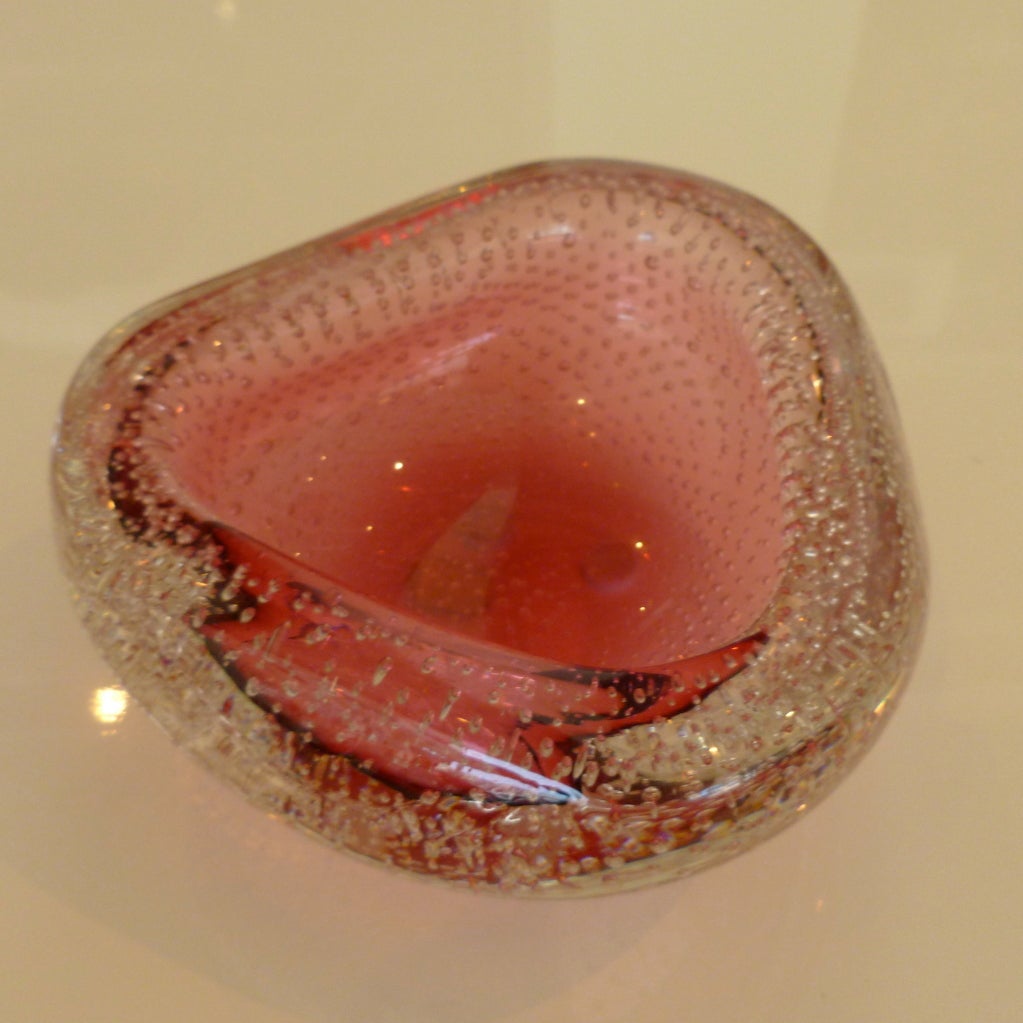 This Murano bowl has the original vintage sticker still on the bottom. It ranges from different shades of cranberry, to a lighter pink... depending on the light.. The profusion of interior clear bubbles are in nearly identical size... and in