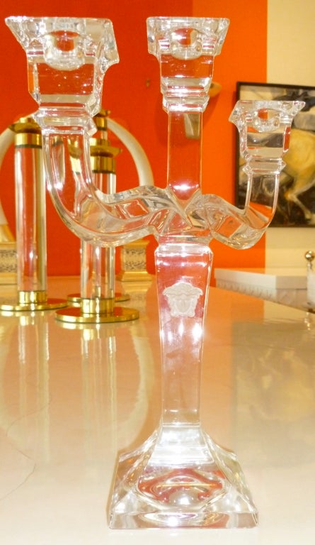 This Versace clear crystal glass  3 arm candelabra/ candlestick
is simple and elegant! It has the raised frosted intaglio Versace signature 
mark and emblem.

