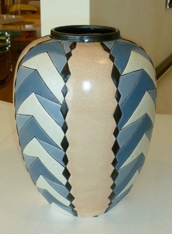 This very unusual period art deco  geometric ceramic vase/vessel is hallmarked on the bottom. it is crackled in the peach/pink portion, and a matt  finish on the COMBINATION blue/off white section.The colors are 2 shades of blue. black, peachy pink