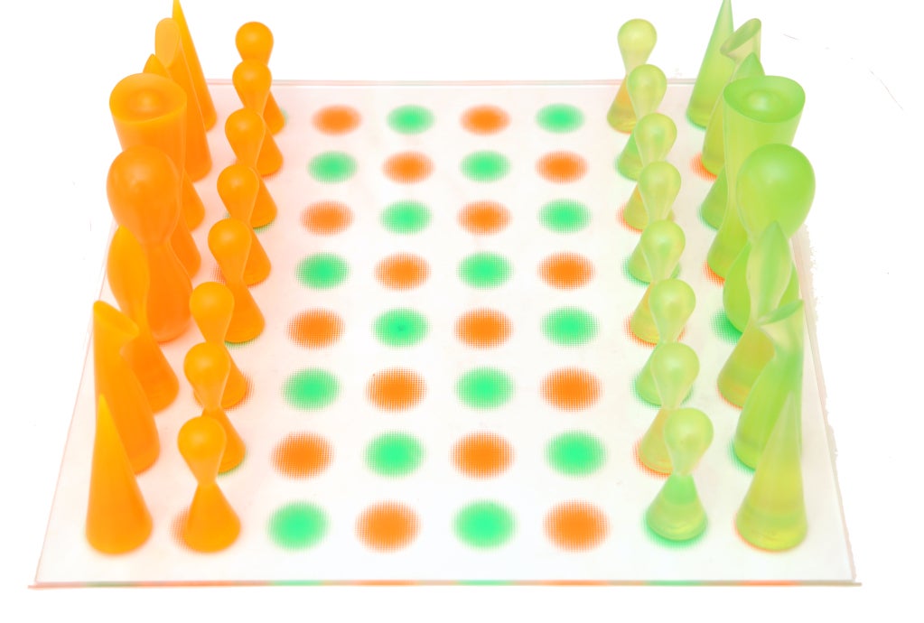 This colorful, artful and fun chess set by the wonderful designer, inventor and innovator: Karim Rashid is out of production from 2002. The chess board is made out of lucite, that looks like candied dots. The  luscious colors are hot orange and lime