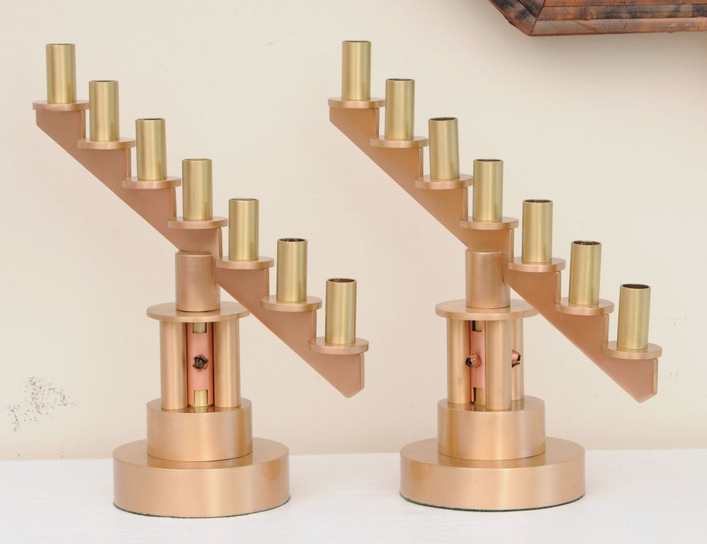 These substantial and very heavy one of a kind handwrought Mid-Century Modern machine parts studio candlesticks are 3 metals of bronze, brass and copper. This pair of most unusual candlesticks and or candelabras make a dramatic statement to any