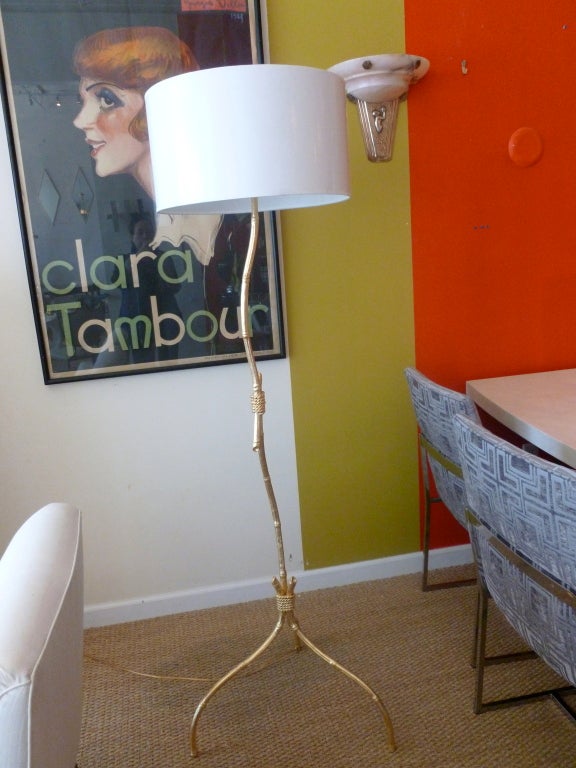 This beautiful and sculptural real gold leaf over wood knotched bamboo and gold leaf rope standing floor lamp looks like a tall elegant twisted twig. It has all been re-wired. However, the shade does not come with it. The two bulb sockets have the