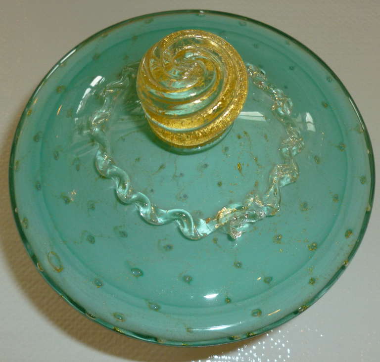 Sea green turquoise meets gold aventurine in this exquisite Murano glass 2 part covered bowl. the gold aventurine look little teardrops floating in the glass The gold aventurine scalloped feet make this Italian Murano bowl so special along with the