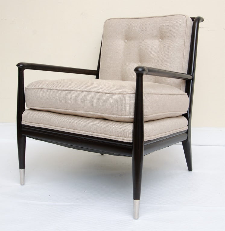These comfortable yet wonderful pair of sculptural Widdicomb lounge chairs have all been redone. The wood is expresso to black ebony with 2 silver tips on each chair.
The slated wood open backs with the tufted buttoned cushions enable the chairs to