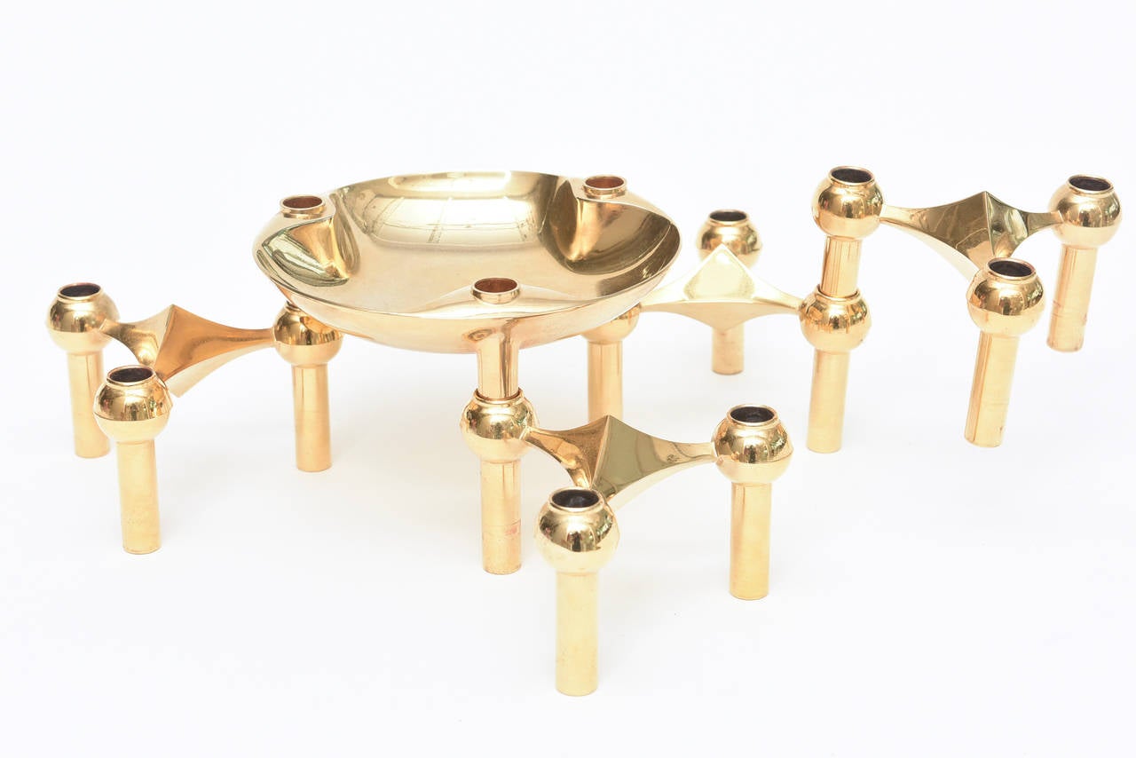 This sculptural, stackable moveable brass candlestick candelabra centerpiece is versatile as it can be made into any arrangement; like a puzzle. They stack, they move, they intersect, they change... what a great sculpture they make in candlestick
