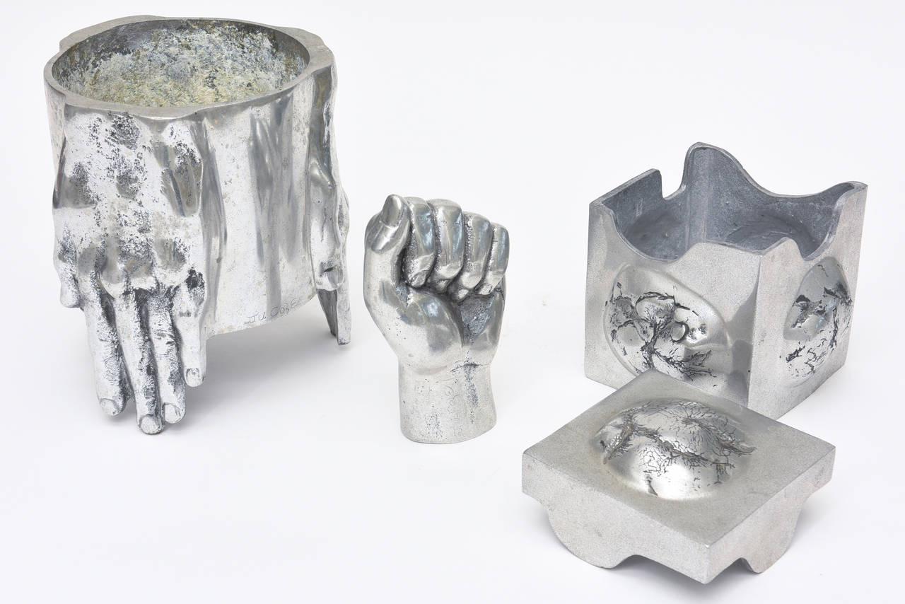 These set of three objects, sculpture are in the style of Richard Etts. There is a vessel, vase and small planter, a two-part box and a fist hand sculpture. The planter can house a beautiful orchid or flowers. These must be sold as a set! The size