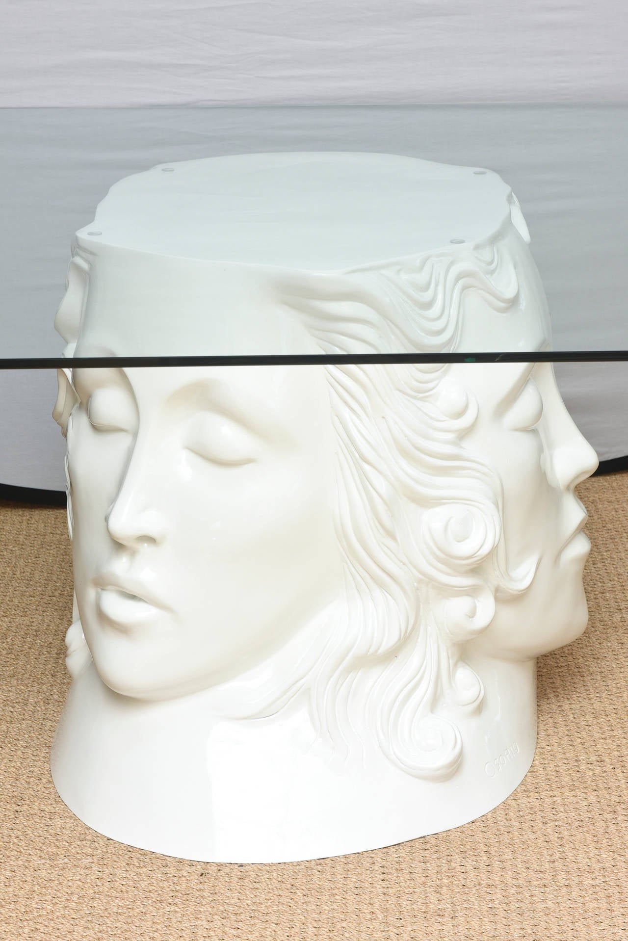 The three serene closed eyed female faces hold court on three sides which are met with the fourth side of tendrils of cascading molded hair. This is art, sculpture, theater and drama all in one as this amazing dining table, desk or entry table. It