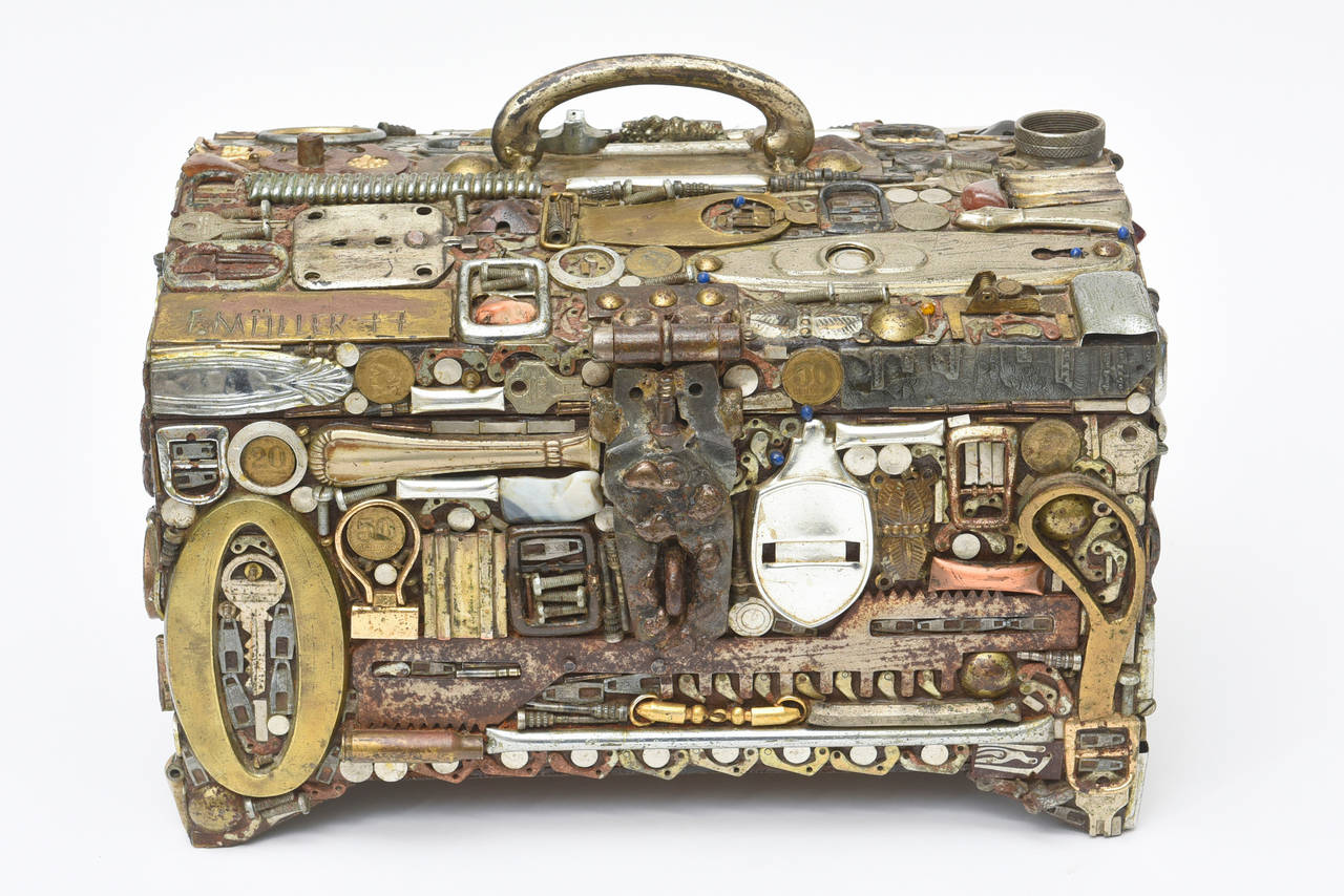 This is art, sculpture and one fantastic large hinged unusual box that is a mix of found objects of mixed metals/ mixed media... it is like a puzzle... There is copper, brass, chrome, aluminum, steel, glass, stones, resin, bronze and etc. What work