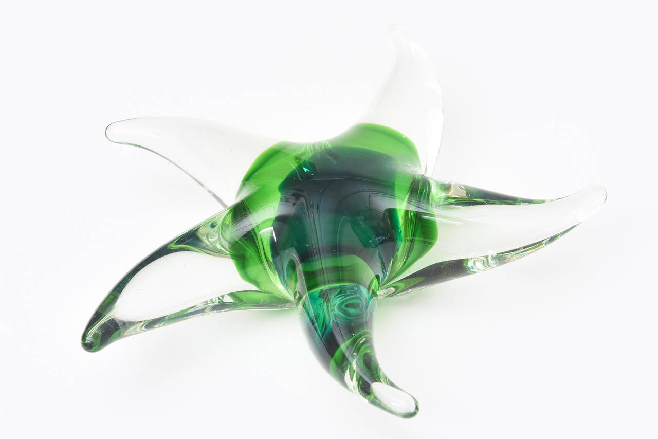 Luscious colors of green meet other colors of green in this Italian Murano glass star fish/object by Seguso. The wonderful colors of many shades of beautiful greens are in the Sommerso technique. Depending on which way the light hits it, changes the
