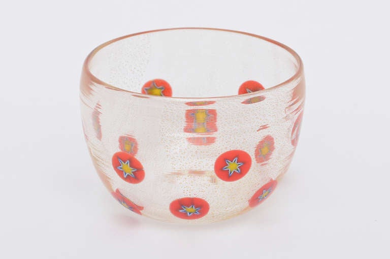 Randomly placed circular Murine stars with red dots yellow and blue outlines make this small but delightful Murano italian glass bowl eye catching!! Pops of color against the clear and gold dust aventurine.