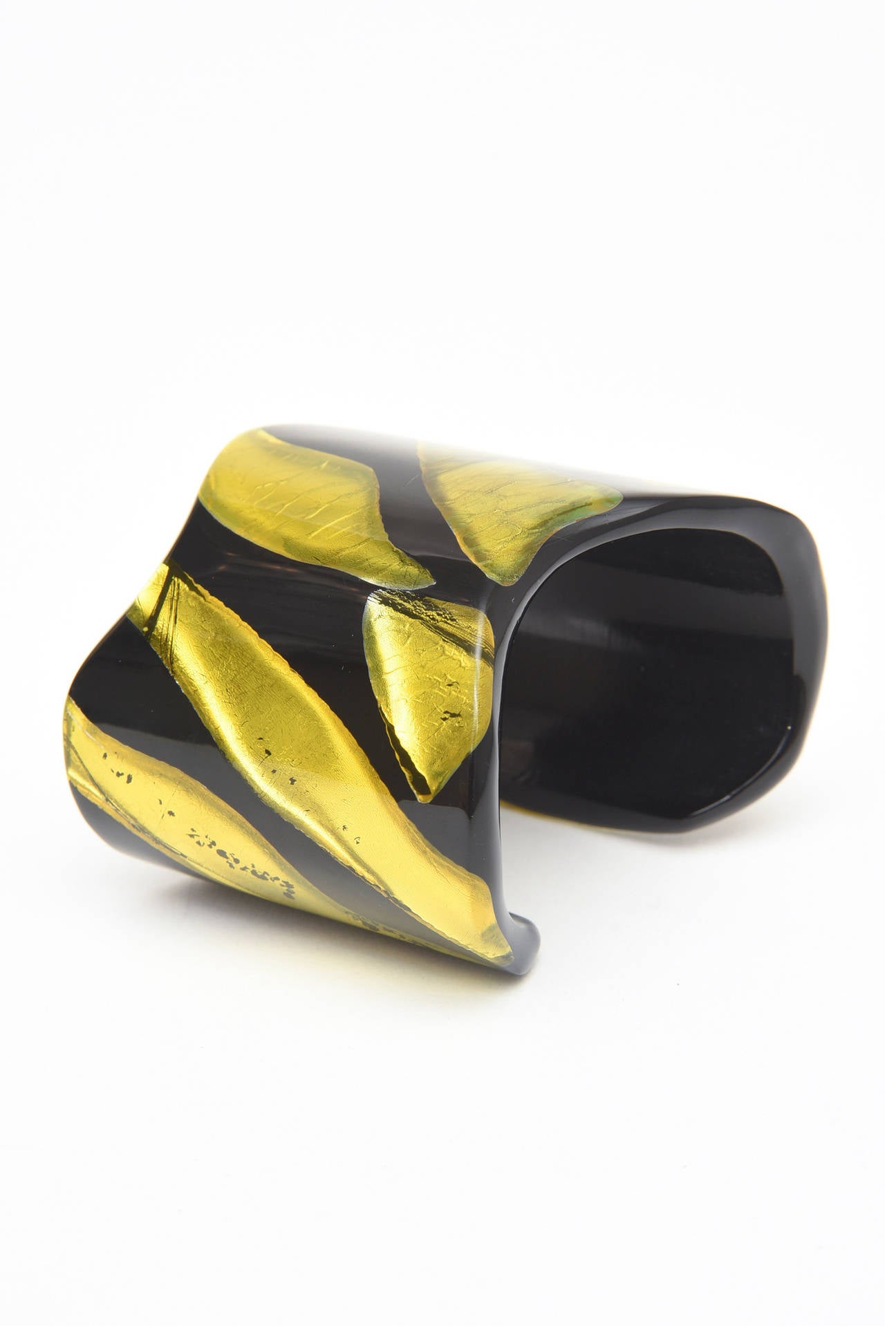 The juxtaposition of embedded chartreuse resin that looks like foil against black plexiglass becomes almost 3 dimensional. This sculptural one of a kind cuff is signed Vigneri 1984 copyright. It is has the shape of the sterling bone cuff bracelet of