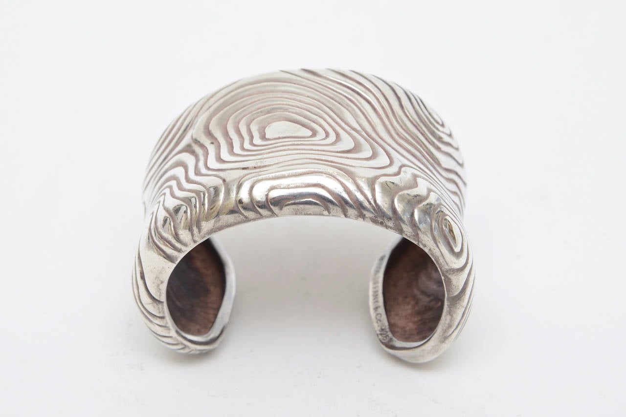 The abstract design work of this amazing thick and substantial sterling silver hallmarked Tiffany cuff  bracelet is sensational.
It is marked Copyright symbol 1996 Tiffany& Co. 925. Seen in the photos..
The interior width is almost 2