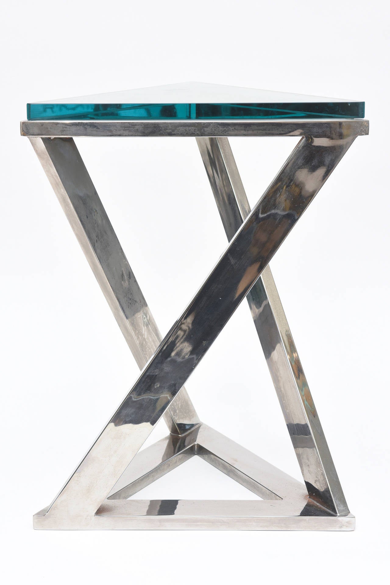 This  sculptural Pace side table has great form. Two Triangles flank the top and bottom with intersecting chromed over steel lines.
The glass top is original and has a hint of green color. The glass top is 1