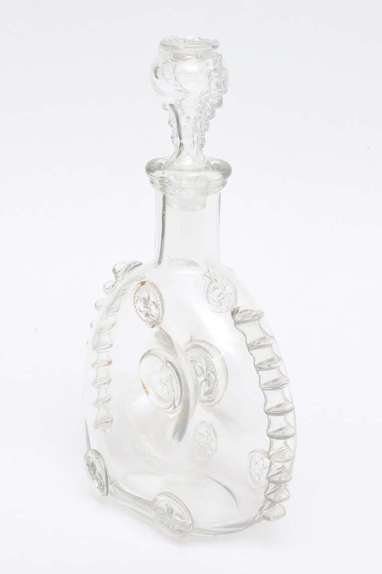 This vintage Crystal Baccarat glass cognac decanter is wonderful! it is Louis Xlll.
Wonderful protrusions of  formed blown glass adorn the edges and medallions of glass are scattered on the body of the decanter.