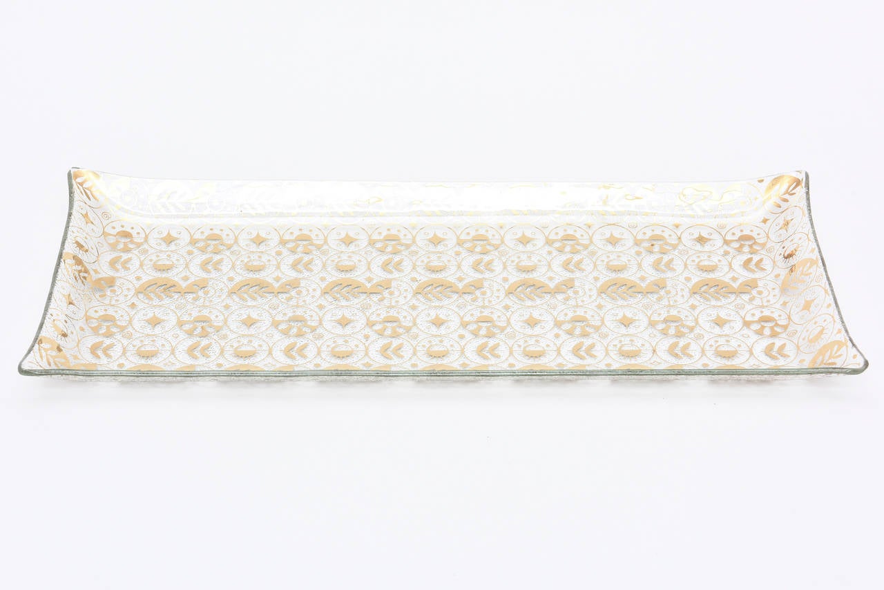 This lovely glass serving tray has a wonderful graphic pattern in gold over clear.
It is signed Georges Briard and is mid century modern. Great for serving or as a desk accessory. The pattern is optical.
The glass is textured on the bottom. The 4