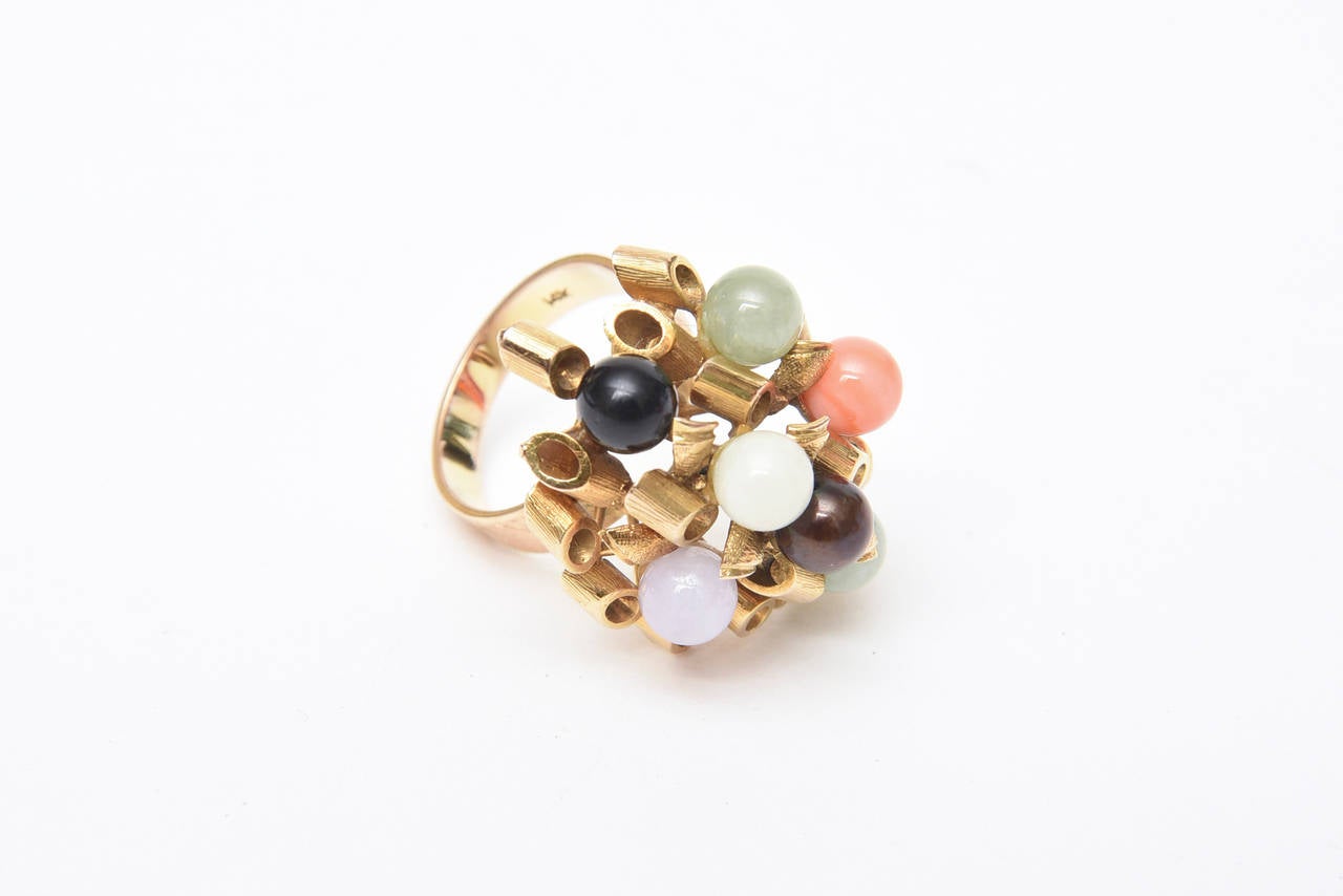 This ever so chic vintage 1960's 14K Gold cluster dome cocktail ring or everyday ring has various round stones in interspersed jade, amethyst, coral and black and white onyx. The gold spiral forms are of raised height. it is a size 7 and can be