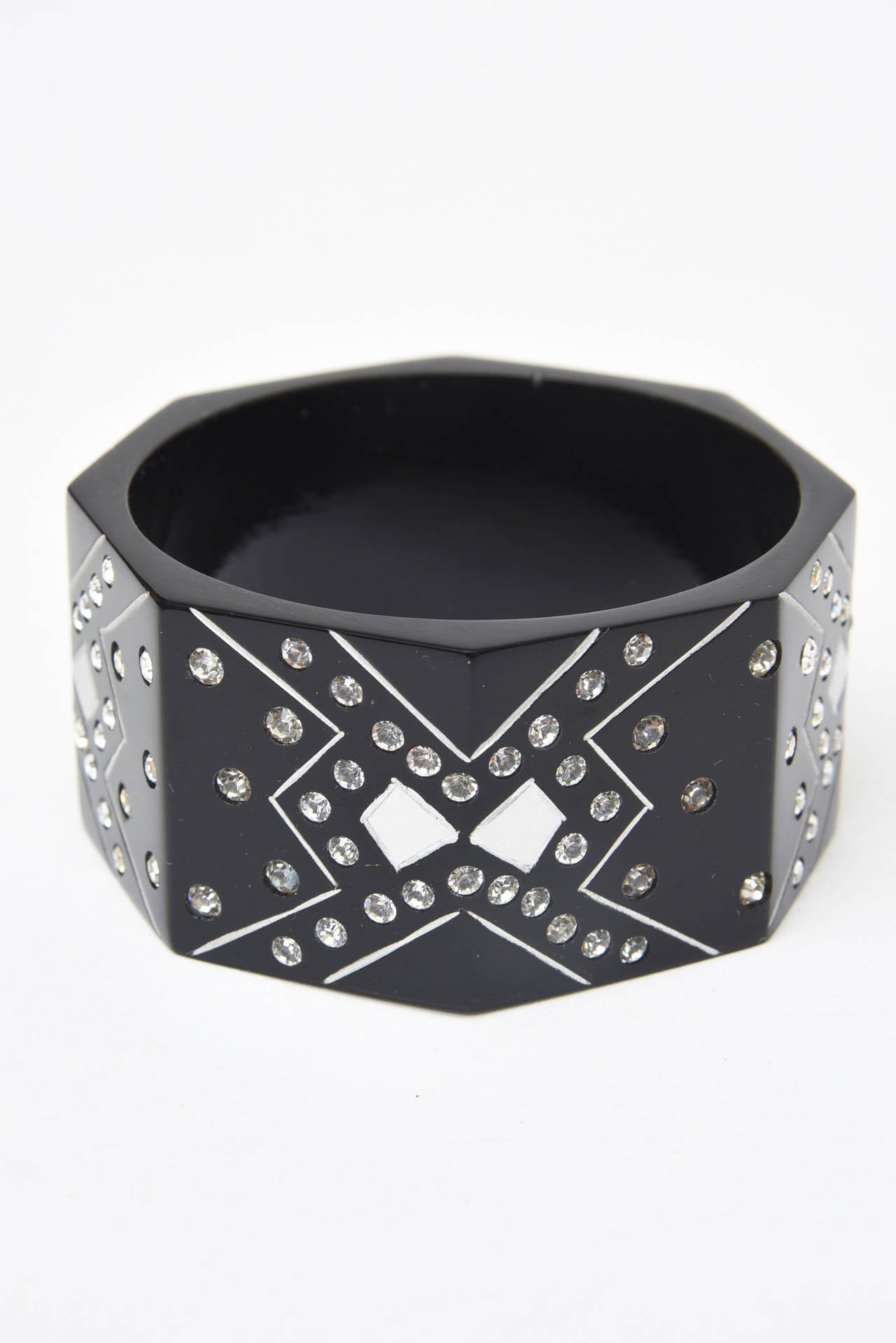  This french resin and rhinestone sculptural cuff bracelet is reminiscent of the Art Deco Period but more modern. It is from the 80's. This will make any wardrobe ensemble sparkle. It will need a wrist size of 6.5 